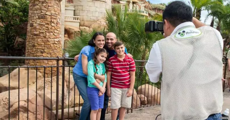 A PhotoPass photographer captures a family portrait
