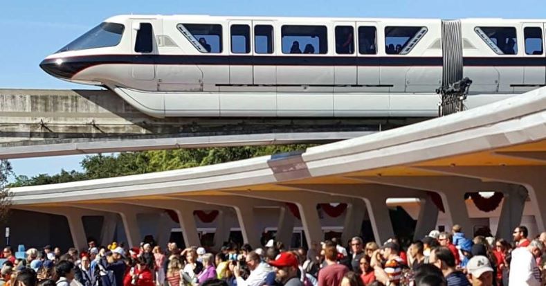 Monorail Black soars overhead as guests mingle below