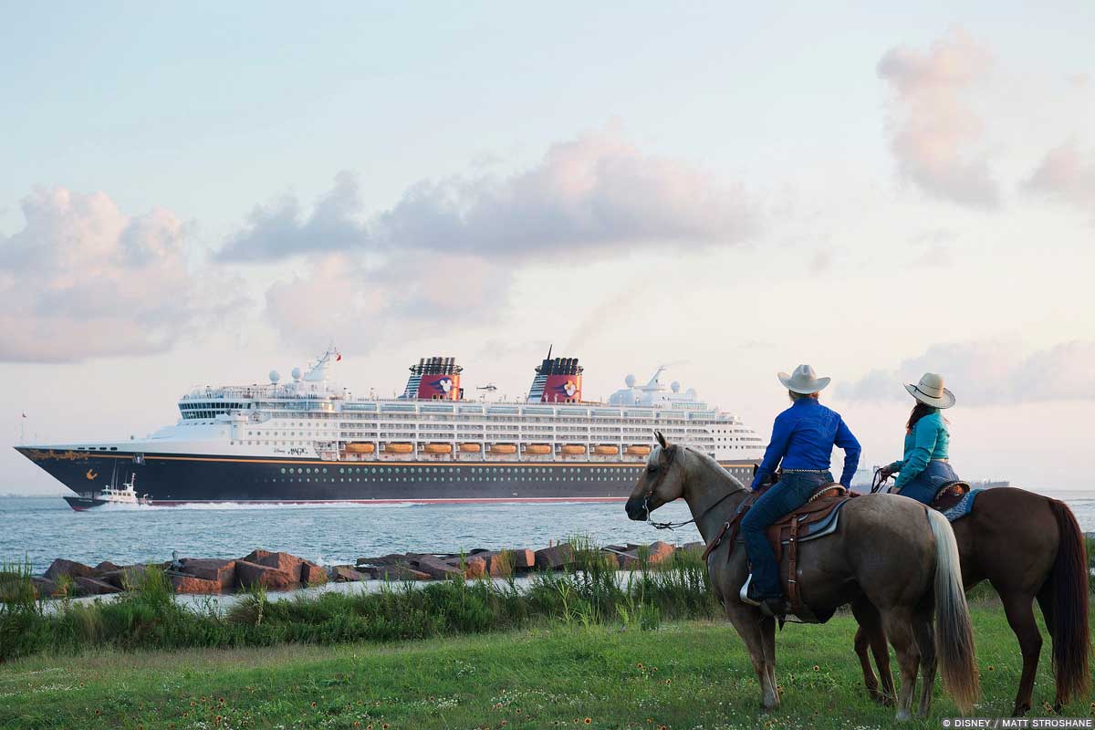 Disney Cruises From Galveston - two persons sitting on horseback watch as the Disney Magic cruise ship sails by