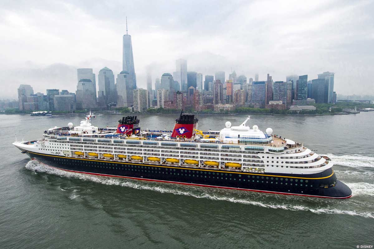 A Disney Cruise Ship sails in front of the New York City skyline