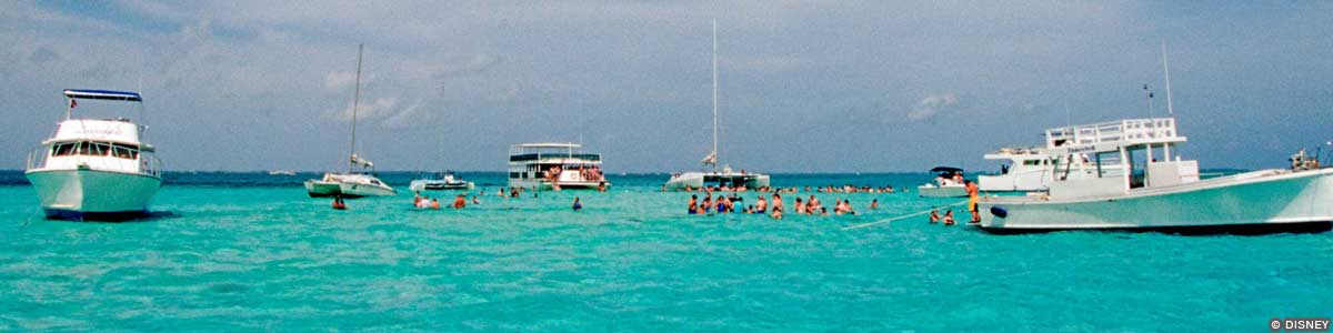 Itineraries – George Town, Grand Cayman Boats floating and people swimming in the waters off Grand Cayman