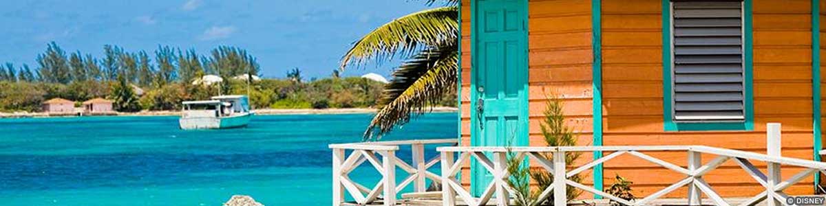 Itineraries – Nassau Crystal waters behind an orange and teal building