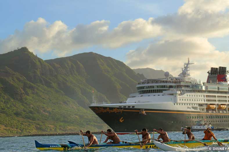 Disney Wonder – Kiwiliwili, Hawaii A Disney Cruise ship sails to Kiwiliwili on the island of Kauai, Hawaii. A longboat being rowed by several people is in the foreground.