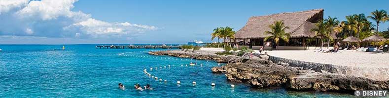 A thatched-roof building along the water in Cozumel, Mexico