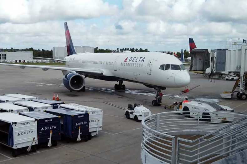 Nearest Airports to Disney’s Cruise Terminal A white jet sits on the tarmac, with support vehicles surrounding it.