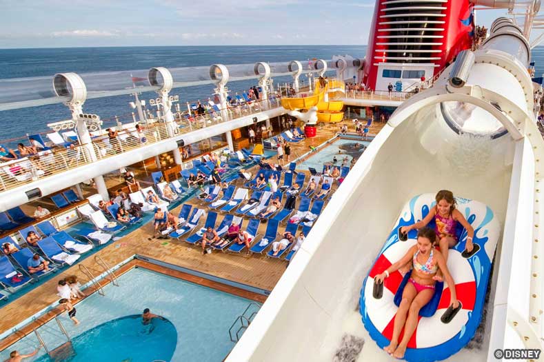 Best Cruise Lines for Kids: two children on an inflated raft ride a water coaster on a cruise ship