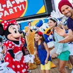 Disney Characters and Cruise Passengers dance together on the deck of a Disney Cruise Ship