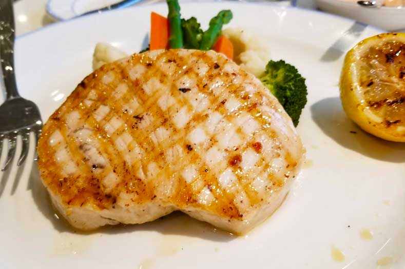 Disney Cruise Food - Grilled Fish served with fresh vegetables and a griddled lemon half.