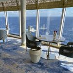 Food on Disney Cruise Line: A Dining Guide (2026) Food on Disney Cruise Line: Tables in front of large seaside windows