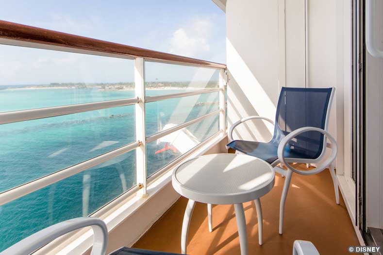 Deck chairs and a small table on a Disney Cruise Ship verandah
