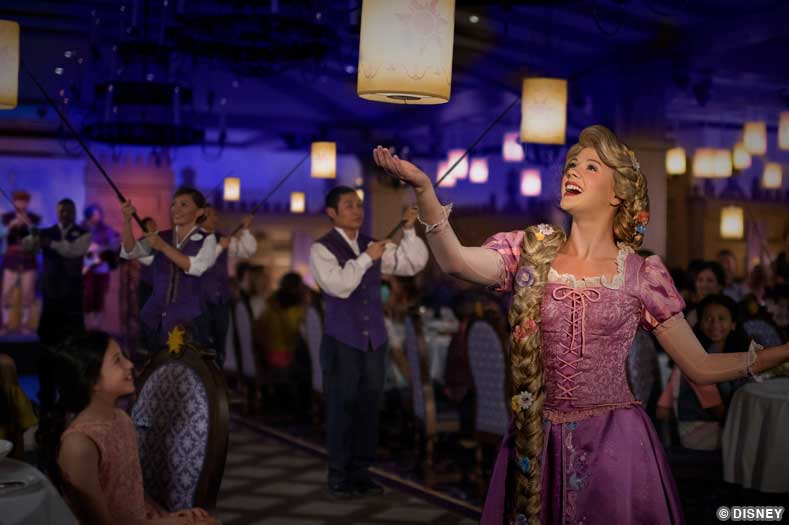 Disney character Rapunzel reaches for a floating lantern in the dining room of Rapunzel's Royal Table