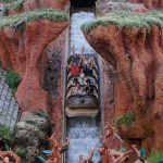 a log-shaped ride vehicle carrying passengers slides down the water flume at the now-closed Splash Mountain ride, which still ranks highly among the Most Popular Rides at Walt Disney World