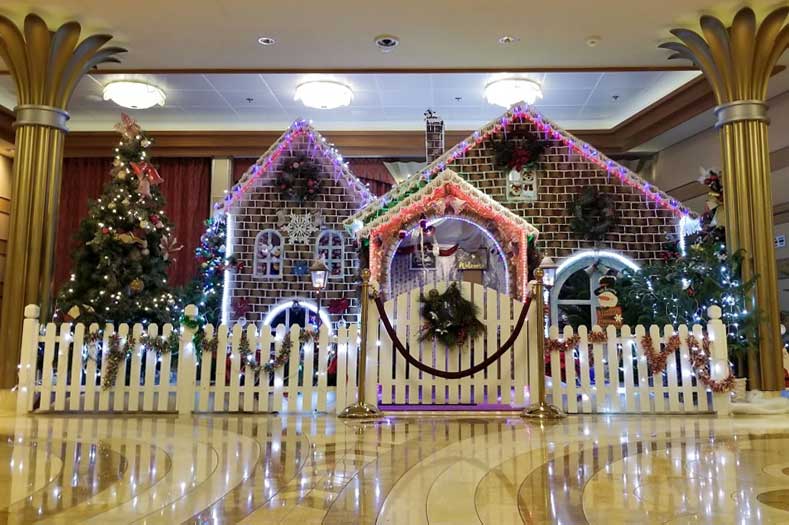 A life-size gingerbread house in the atrium lobby of a Disney Cruise Ship