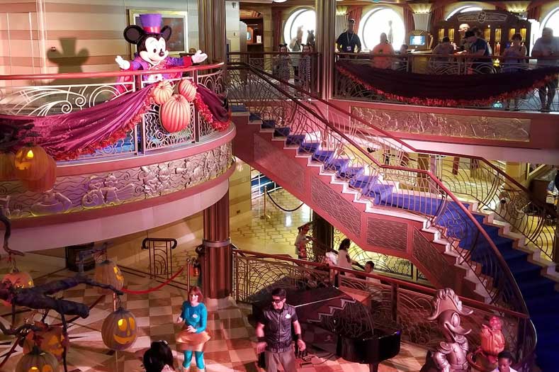 Disney Cruises with Specialty Themes: Mickey Mouse, from a balcony, greets Guests during a Halloween on the High Seas specialty cruise