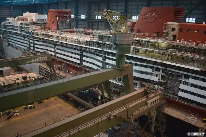 Image showing the Disney Treasure cruise ship under construction, with the two large funnels taking a prominent position