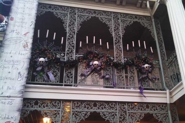 Additional decorations are added outside of Haunted Mansion in a Nightmare before Christmas overlay