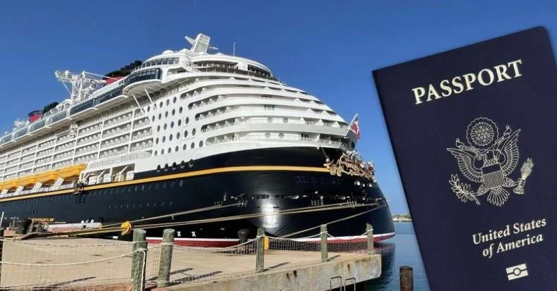 A passport being held up for the camera in front of a Disney Cruise Ship