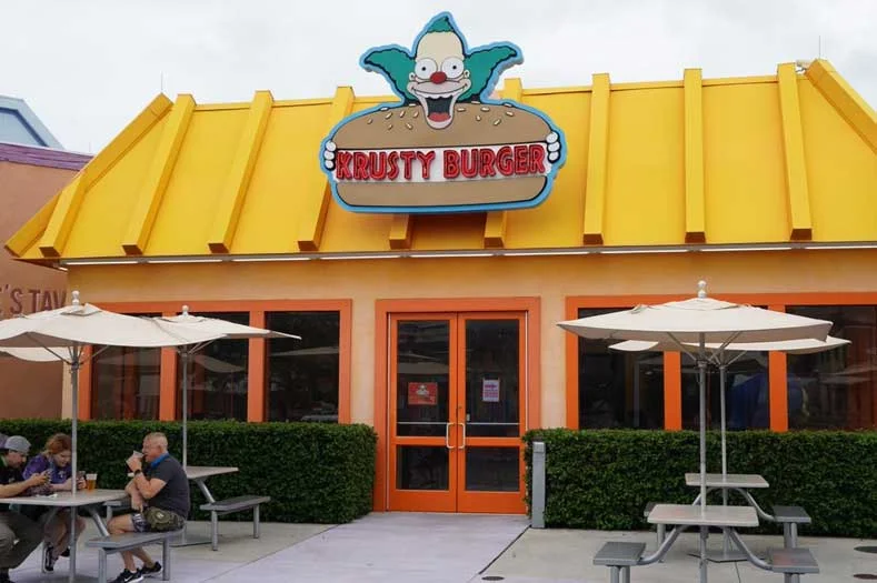 Exterior of Krusty Burger, with image of Krusty the Clown atop the building