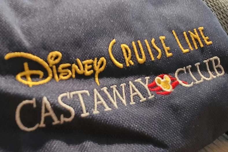 An embroidered Disney Cruise Line Castaway Club logo on a backpack
