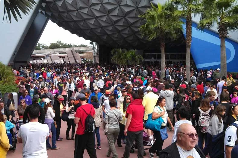 Large number of people walking underneath Spaceship Earth at EPCOT on New Year's Eve