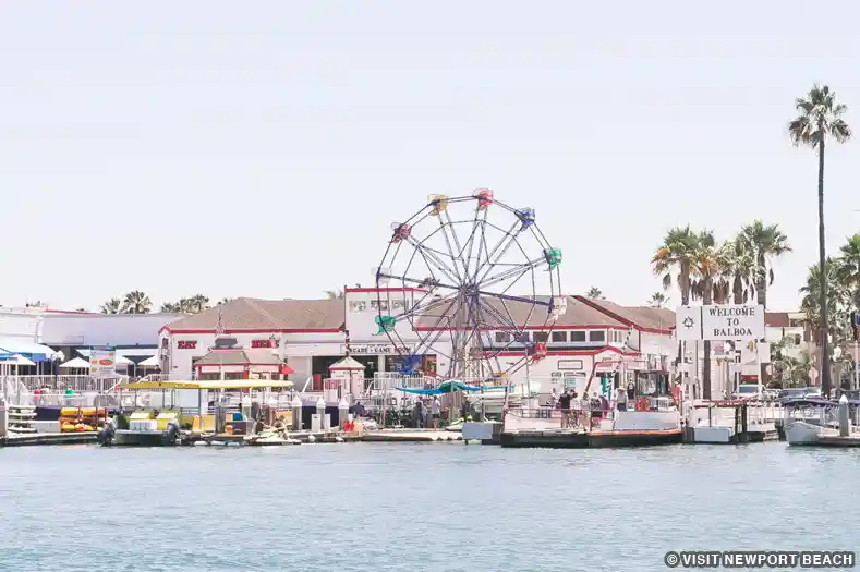 A Ferris Wheel rises over Balboa Village harbor
