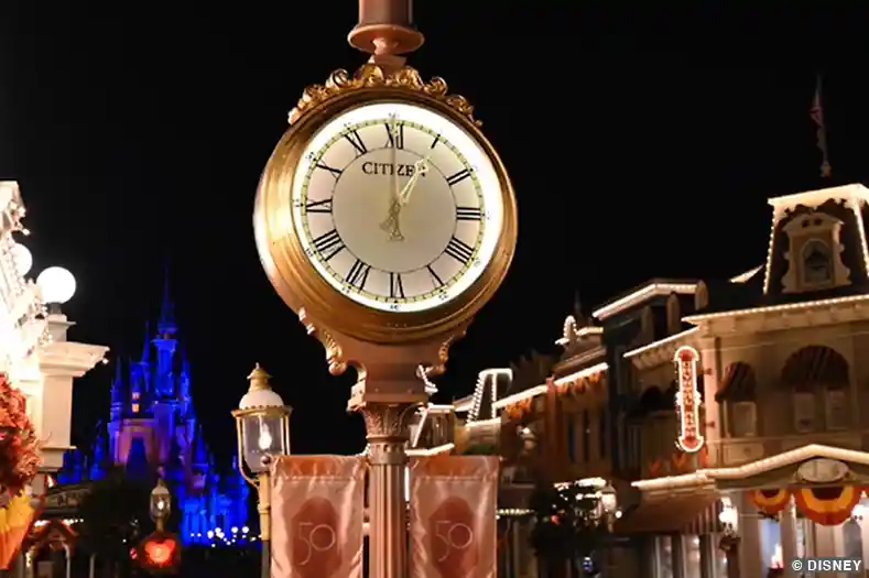 Closing Times for Disney World Parks: A large street clock shows 1AM on Main Street USA at Magic Kingdom theme park