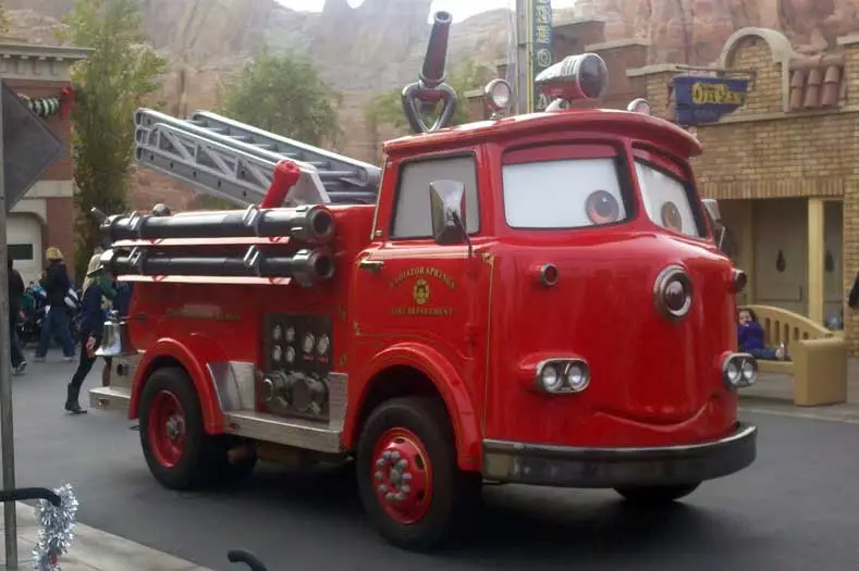 The PIXAR character Red, a fire truck, greets Guests at Cars Land.