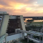 The Contemporary Resort exterior at sunset, with Monorails approaching the building