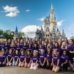 Best Disney Travel Agency to Work For? A group of Vacationeer travel agents in front of Cinderella Castle