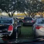 How Much is Disneyland Parking? Cars parked in the grass at EPCOT on New Year's Eve at Disney World