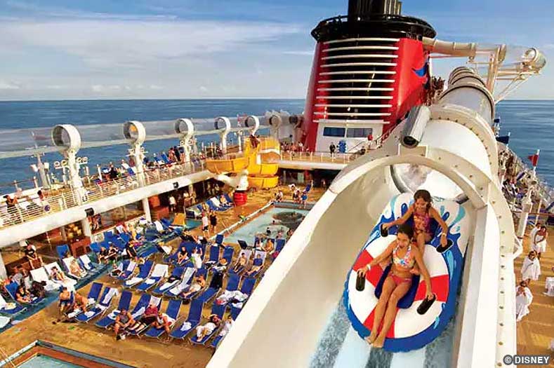 Two riders on a raft are propelled by water through elevated tubes on the AquaDuck, a water ride on some Disney cruise ships