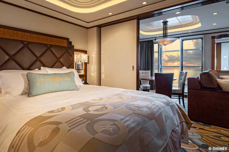 A plush bed and sofa with a verandah balcony