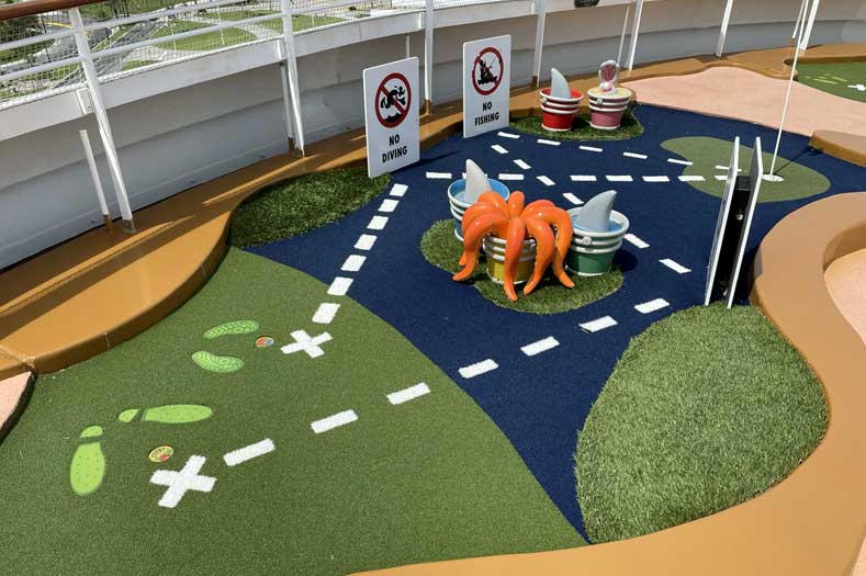 A miniature golf course hole, complete with silly additions such as an octopus in a bucket of water