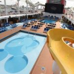A Guide to Planning a Group Cruise Mickey-shaped pool and bright yellow waterslide