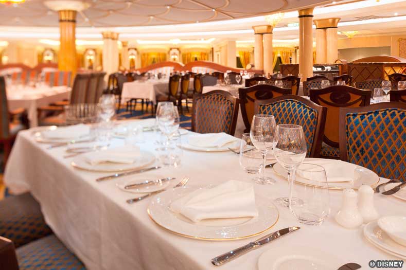 An elegantly-set dining table with white tablecloth