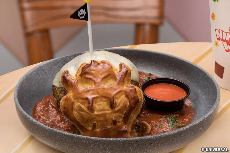 a one-pound meatball topped with mozzarella cheese, in a mushroom marinara sauce with a Bowser-inspired puff pastry and a side of hot sauce