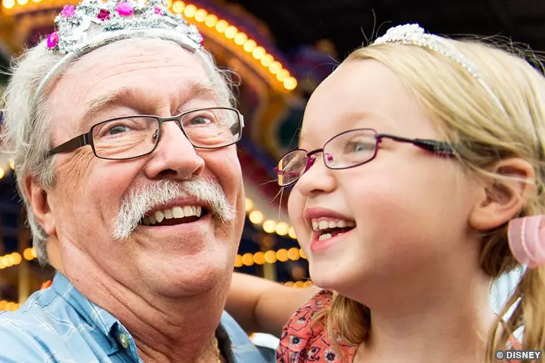 senior citizen with child at disney world