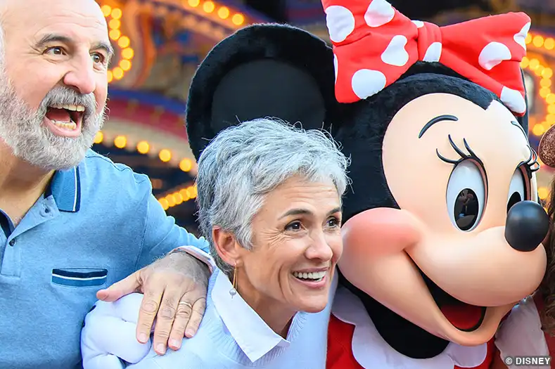 Seniors at Disney World pose with Minnie Mouse
