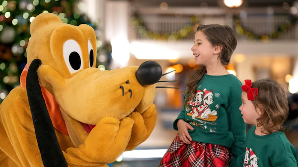 two girls and goofy at disney world during the winter two girls and goofy at disney world during the winter