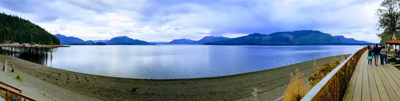 Water and distant mountains, from the perspective of a long boardwalk